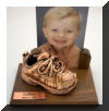 Bronzed shoes on walnut base with walnut frame