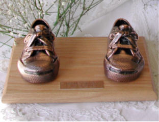 Bronzed shoes on oak base