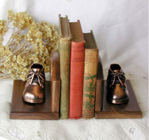 Bronzed shoes on walnut bookends
