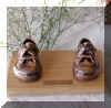 Bronzed shoes on oak base