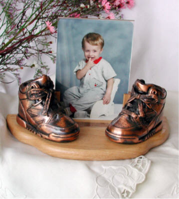 Bronzed on curved oak base with clear frame