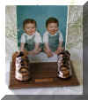 Bronzed shoes on walnut base with clear frame