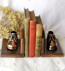 Bronzed shoes on walnut bookends